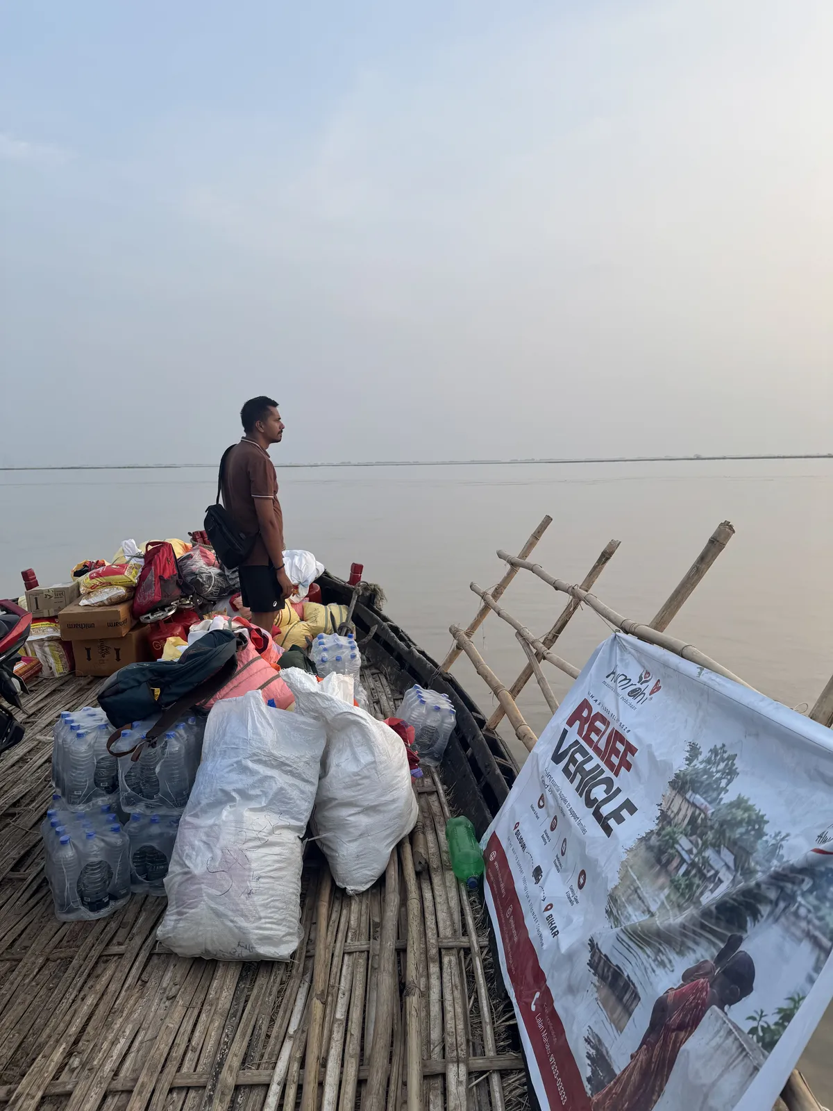 Bihar, September 2026: the Humrahi relief boat crossing floodwater over a submerged village on the way to Bakia Sukhay