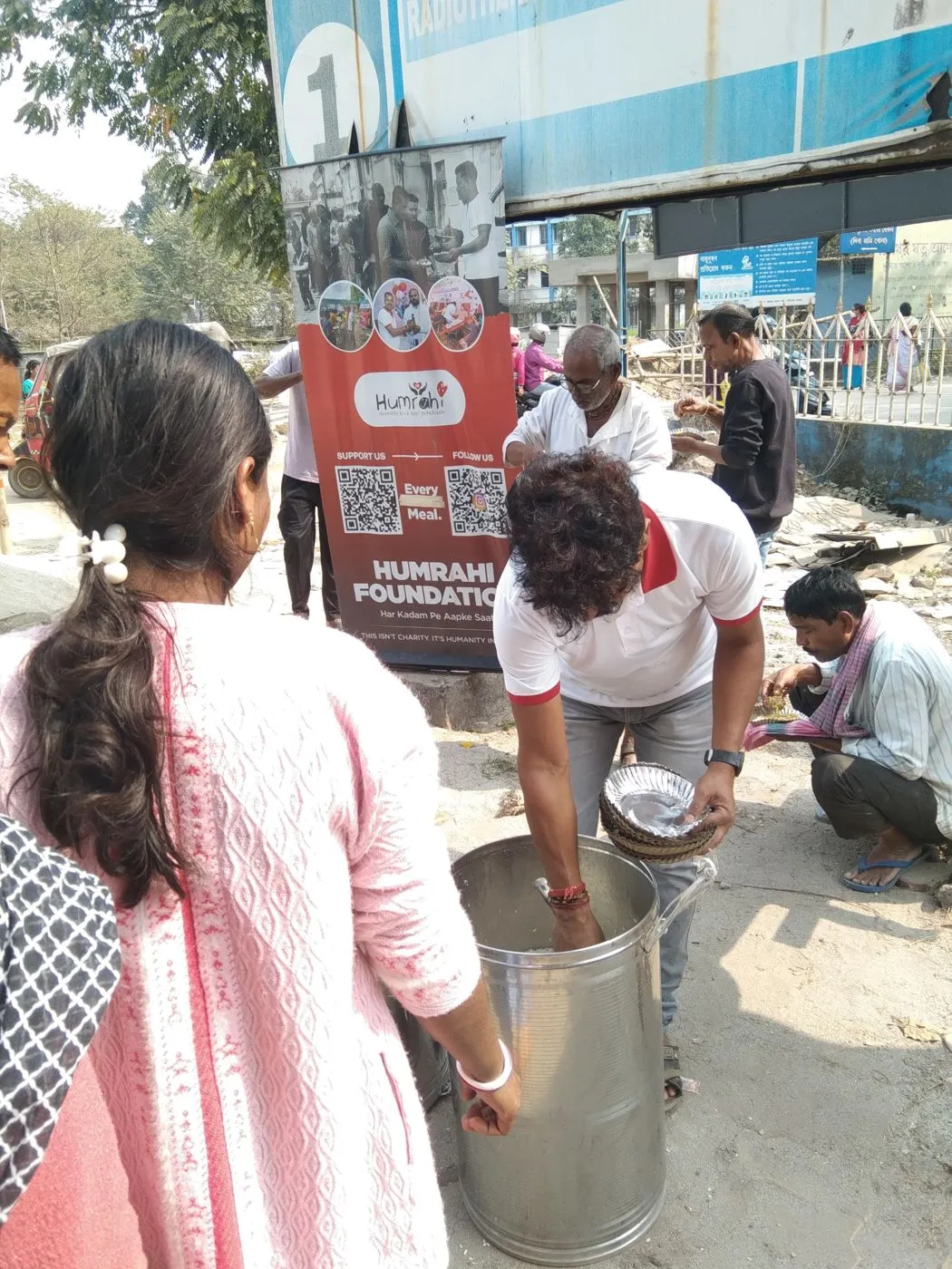 Volunteers cooking a large batch of food for the day's distribution round