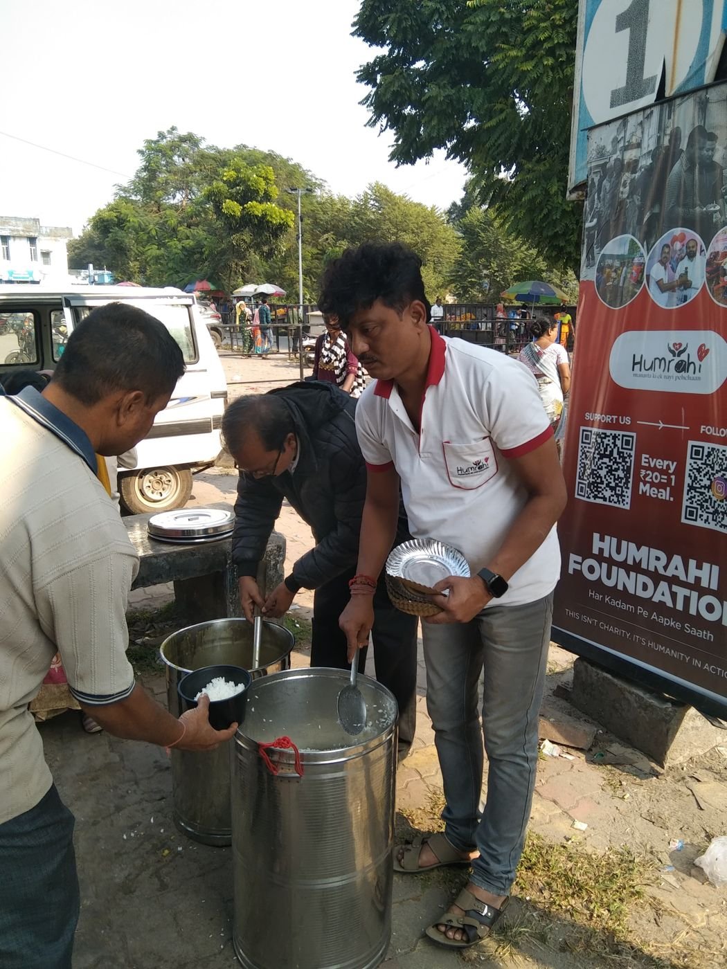 A volunteer handing a filled plate to someone in line