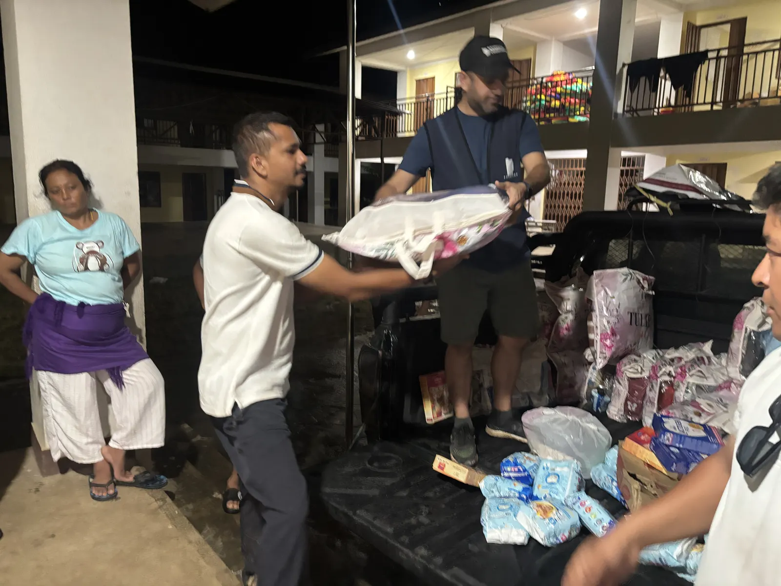 Nepal, September 2026: relief handed over at a holding camp, Humrahi and KarmaYog volunteers with families